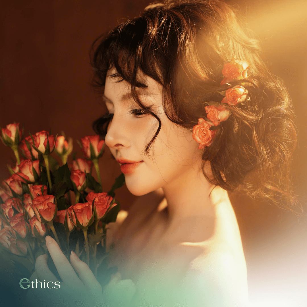 Young, radiant female client holding a bouquet of roses one month after structural rhinoplasty